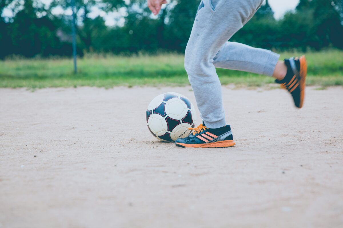 child kicking soccer ball - photo by Markus Spiske from Unsplash